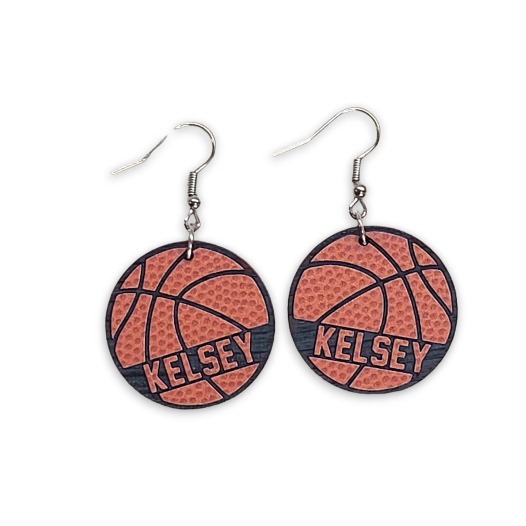 Personalized orange basketball earrings engraved with the name Kelsey